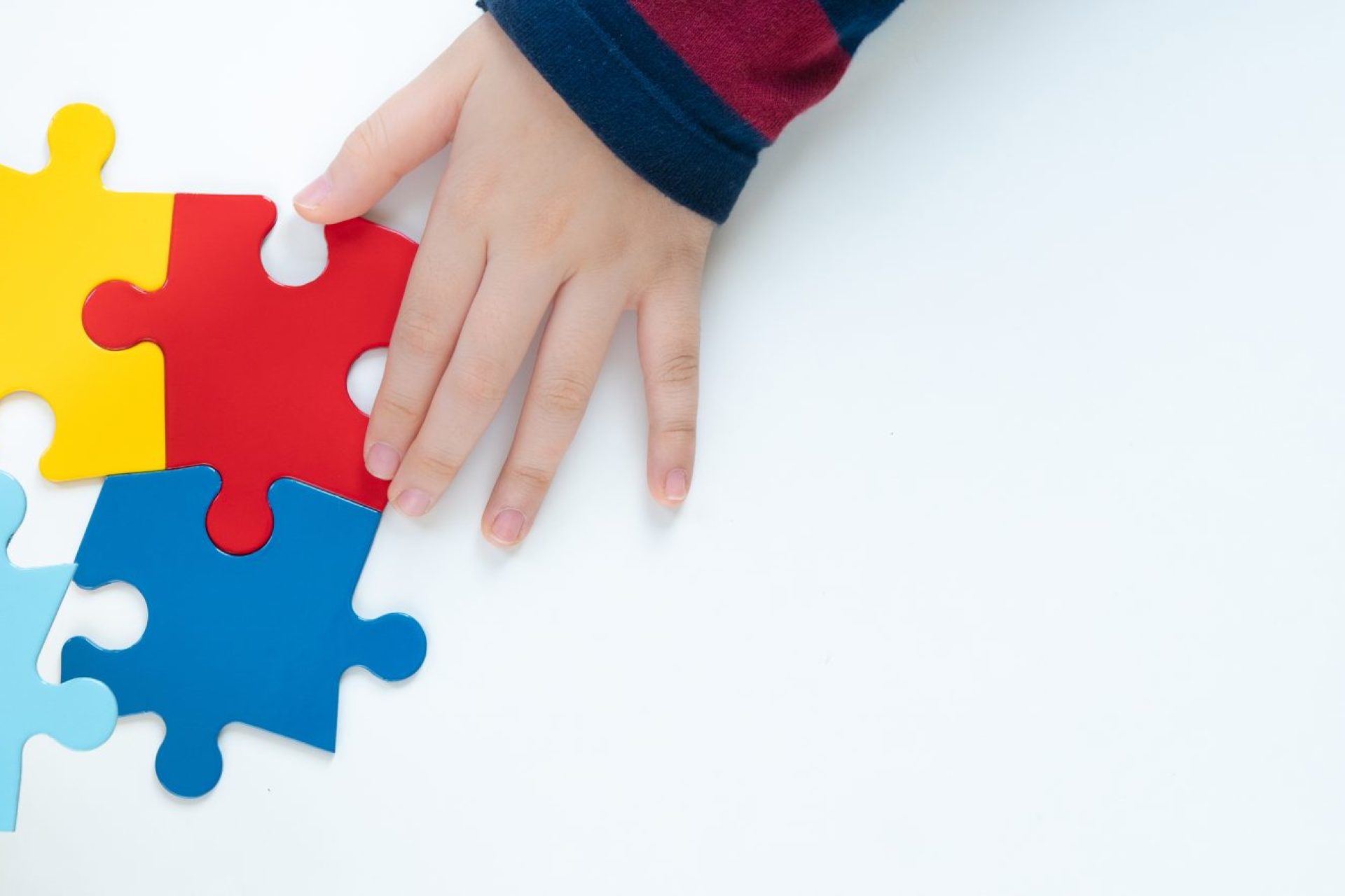 Top,View,Hands,Of,A,Little,Child,Arranging,Color,Puzzle